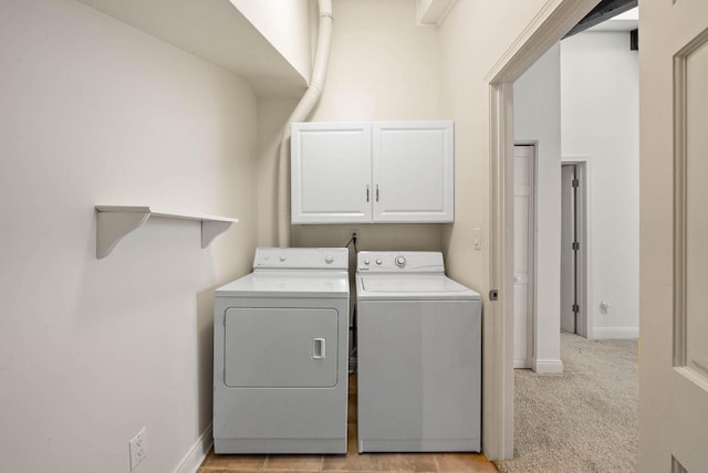 840 Woodland Ct Unit Ee-1, Fontana, WI 53125 - laundry area featuring cabinet space, washing machine and clothes dryer, and baseboards