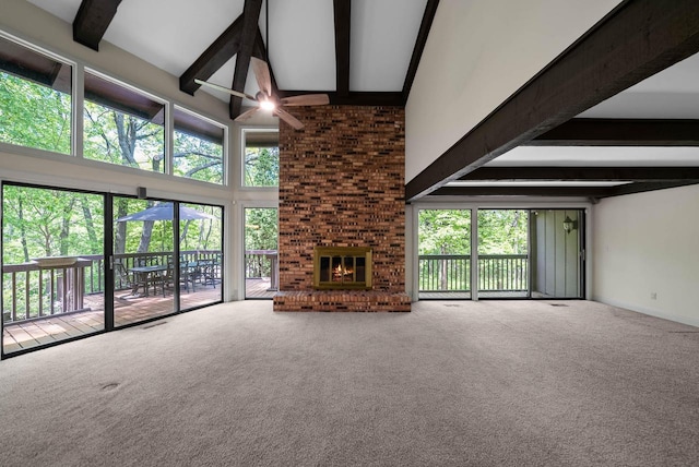 840 Woodland Ct Unit Ee-1, Fontana, WI 53125 - unfurnished living room featuring a towering ceiling, beamed ceiling, carpet flooring, and a brick fireplace