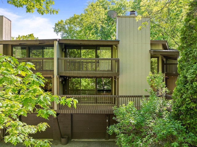 840 Woodland Ct Unit Ee-1, Fontana, WI 53125 - rear view of property with a chimney, a balcony, and an attached garage