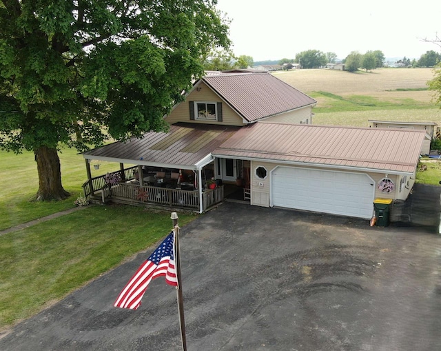 109 N Water St, Eastman, WI 54626 - view of front of property featuring a porch, a garage, asphalt driveway, and a front yard