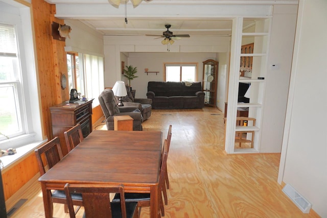 109 N Water St, Eastman, WI 54626 - dining area with ceiling fan, beam ceiling, and wood walls