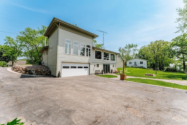 5420 W Peninsula Dr, Waterford, WI 53185 - view of property with asphalt driveway, an attached garage, and a front yard