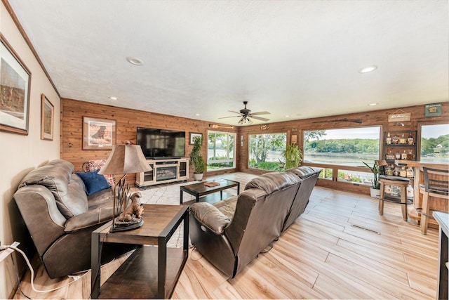 5420 W Peninsula Dr, Waterford, WI 53185 - living area featuring wooden walls, healthy amount of natural light, a ceiling fan, recessed lighting, and light wood-style floors