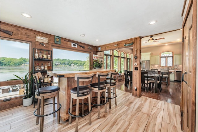 5420 W Peninsula Dr, Waterford, WI 53185 - indoor bar featuring stainless steel appliances, recessed lighting, light wood finished floors, tasteful backsplash, and a ceiling fan