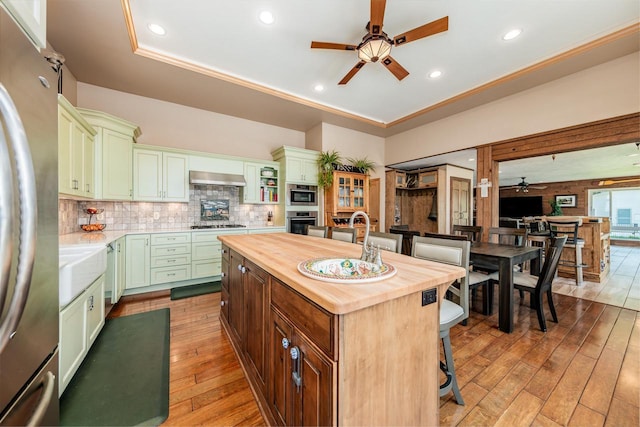 5420 W Peninsula Dr, Waterford, WI 53185 - kitchen with a ceiling fan, green cabinetry, butcher block countertops, appliances with stainless steel finishes, and light wood finished floors