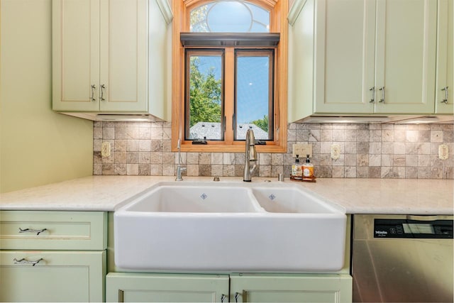 5420 W Peninsula Dr, Waterford, WI 53185 - kitchen featuring stainless steel dishwasher, a sink, green cabinetry, backsplash, and light stone countertops