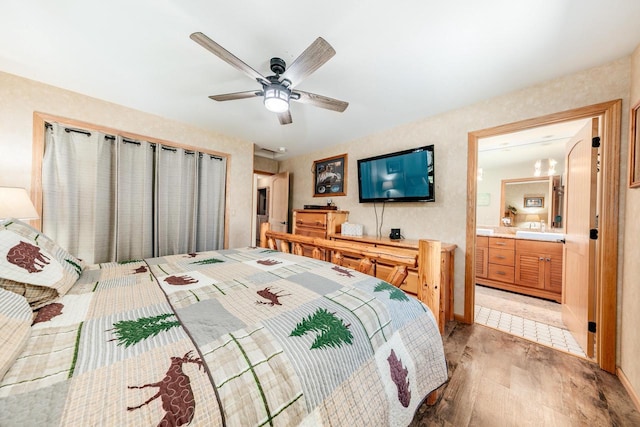 5420 W Peninsula Dr, Waterford, WI 53185 - bedroom with light wood finished floors, connected bathroom, and a ceiling fan