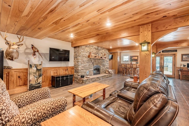 5420 W Peninsula Dr, Waterford, WI 53185 - living room with arched walkways, wainscoting, wooden ceiling, a fireplace, and wood finished floors