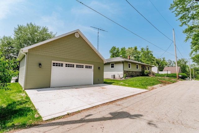 5420 W Peninsula Dr, Waterford, WI 53185 - view of front facade featuring a garage, a front lawn, an outdoor structure, cooling unit, and stone siding