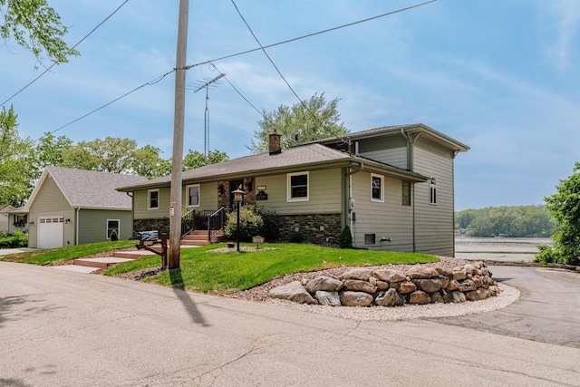 5420 W Peninsula Dr, Waterford, WI 53185 - view of front of property with a chimney, a front lawn, and stone siding