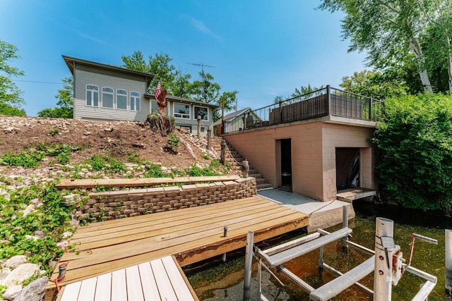 5420 W Peninsula Dr, Waterford, WI 53185 - back of house with stairway, a deck, and concrete block siding