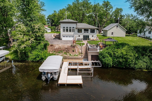 5420 W Peninsula Dr, Waterford, WI 53185 - rear view of property with boat lift, a water view, a yard, and view of scattered trees