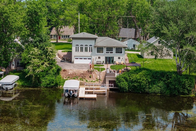 5420 W Peninsula Dr, Waterford, WI 53185 - back of property with boat lift, a water view, a garage, and a yard
