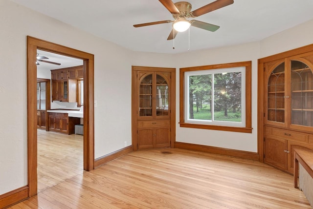 4438 County Road H Prt, Washington, WI 53074 - unfurnished dining area with light wood finished floors, radiator, and baseboards