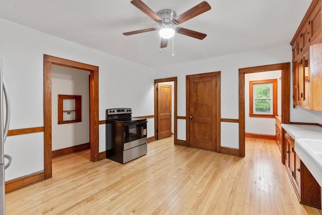 4438 County Road H Prt, Washington, WI 53074 - kitchen with electric range, baseboards, light wood-style flooring, and light countertops