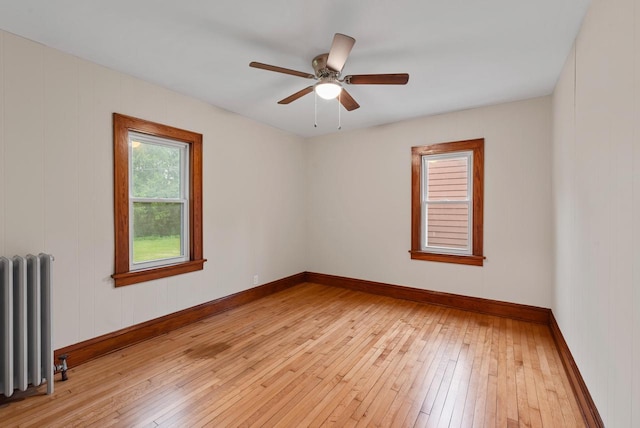 4438 County Road H Prt, Washington, WI 53074 - empty room featuring radiator heating unit, light wood-type flooring, and baseboards