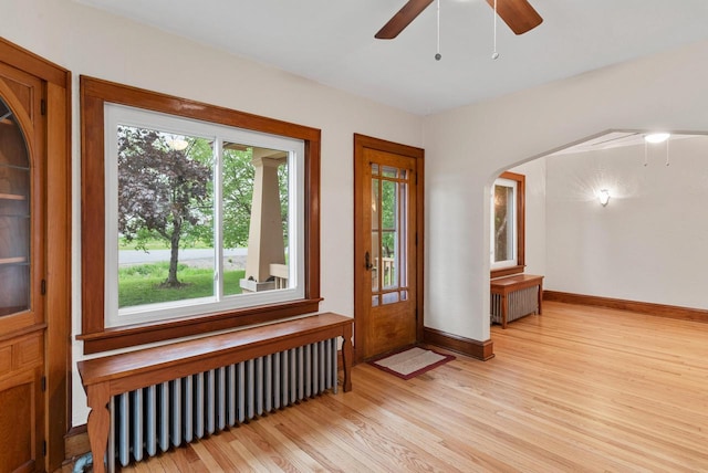 4438 County Road H Prt, Washington, WI 53074 - foyer featuring radiator, ceiling fan, light wood-style flooring, and baseboards