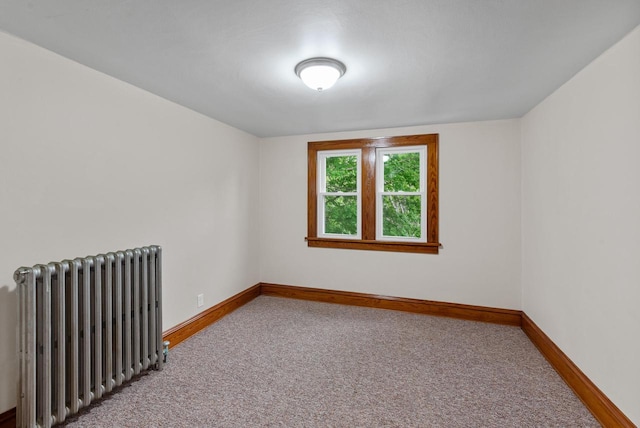 4438 County Road H Prt, Washington, WI 53074 - spare room featuring radiator heating unit, carpet flooring, and baseboards