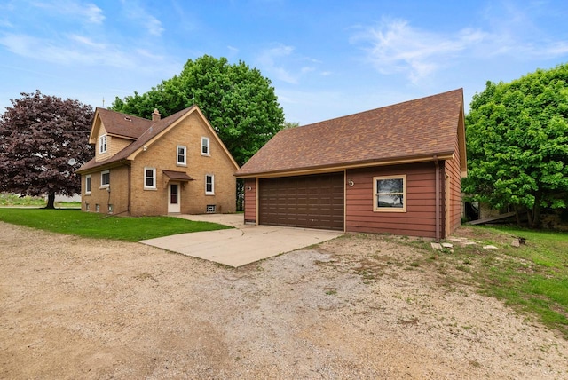 4438 County Road H Prt, Washington, WI 53074 - view of front of house featuring an outbuilding, driveway, and a garage