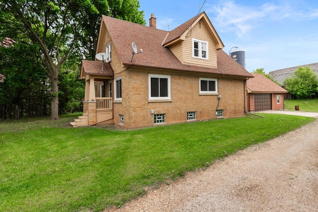 4438 County Road H Prt, Washington, WI 53074 - view of property exterior featuring a chimney, a garage, a lawn, and driveway