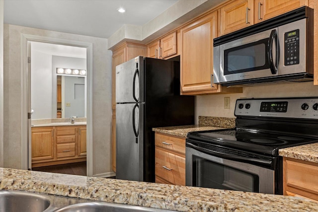 270 E Highland Ave Unit 213, Milwaukee, WI 53202 - kitchen with stainless steel appliances, a sink, light brown cabinets, and light stone counters