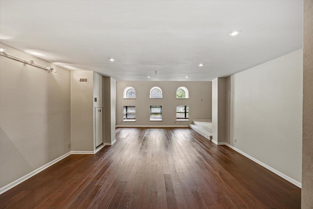 270 E Highland Ave Unit 213, Milwaukee, WI 53202 - unfurnished living room with dark wood finished floors, baseboards, stairway, and recessed lighting