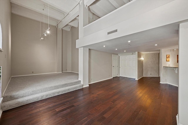 270 E Highland Ave Unit 213, Milwaukee, WI 53202 - unfurnished living room featuring baseboards, hardwood / wood-style flooring, beamed ceiling, a towering ceiling, and recessed lighting