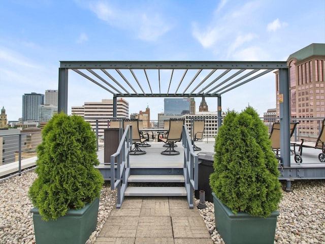 270 E Highland Ave Unit 213, Milwaukee, WI 53202 - view of patio featuring outdoor dining space, a wooden deck, a pergola, and a view of city
