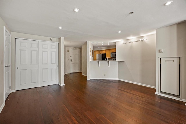 270 E Highland Ave Unit 213, Milwaukee, WI 53202 - unfurnished living room featuring baseboards, dark wood-style flooring, and recessed lighting