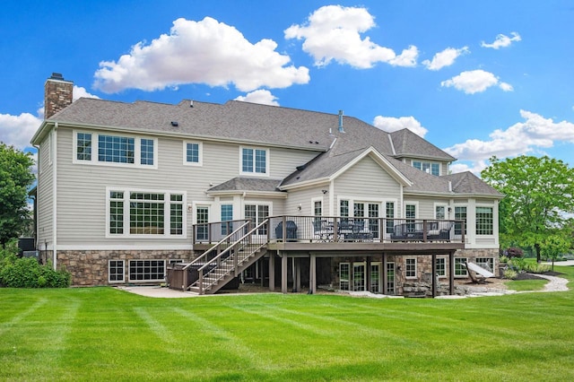 1252 Mary Hill Cir, Hartland, WI 53029 - back of property with a wooden deck, a patio area, stairs, stone siding, and a lawn