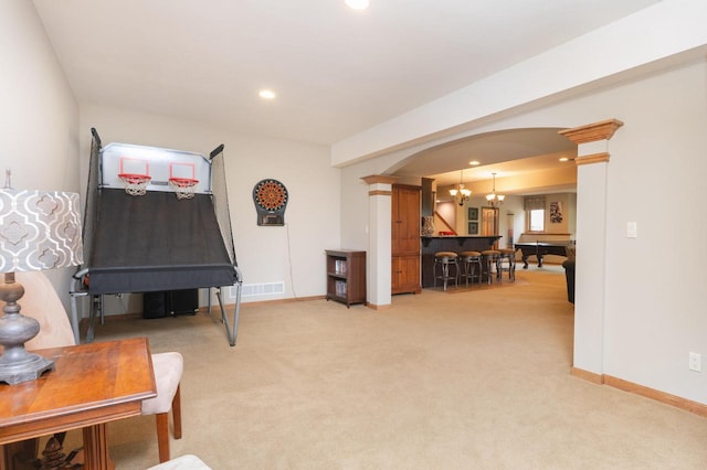 1252 Mary Hill Cir, Hartland, WI 53029 - living area featuring ornate columns, arched walkways, light carpet, baseboards, and recessed lighting