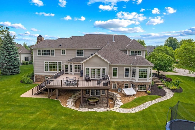 1252 Mary Hill Cir, Hartland, WI 53029 - back of house with stairs, stone siding, a deck, and a yard