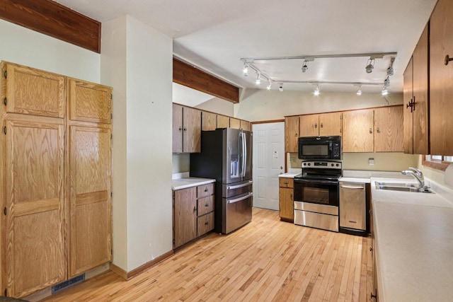 8845 388th Ave, Burlington, WI 53105 - kitchen with appliances with stainless steel finishes, light wood-style flooring, light countertops, and vaulted ceiling