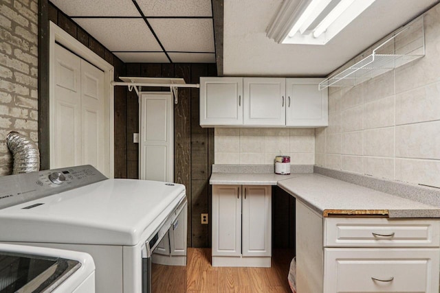 8845 388th Ave, Burlington, WI 53105 - washroom with washer / clothes dryer, cabinet space, and light wood-style floors