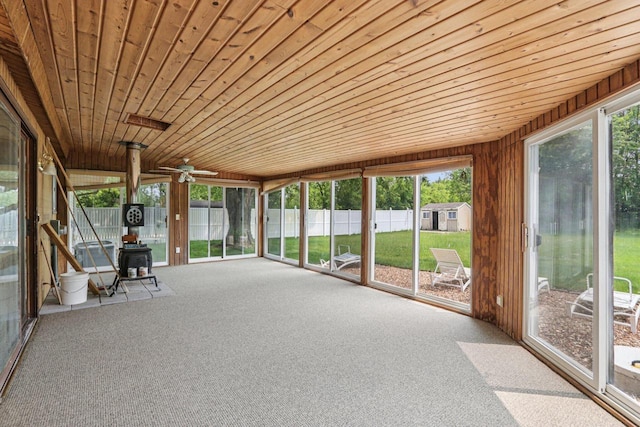 8845 388th Ave, Burlington, WI 53105 - unfurnished sunroom with a wood stove and a ceiling fan