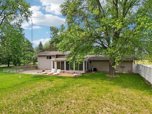 8845 388th Ave, Burlington, WI 53105 - rear view of property with a fenced backyard, a sunroom, and a patio area