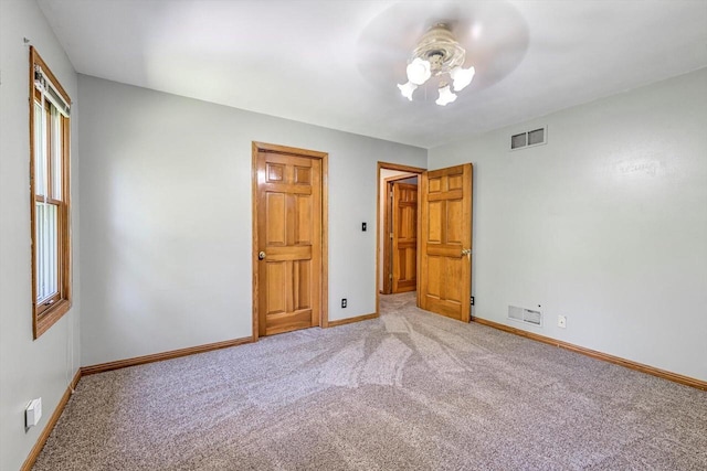 6705 Brian Dr, Waterford, WI 53185 - unfurnished bedroom featuring light colored carpet, baseboards, and a ceiling fan