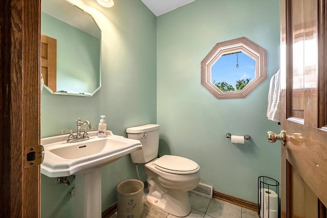 6705 Brian Dr, Waterford, WI 53185 - half bath featuring toilet, tile patterned floors, and baseboards