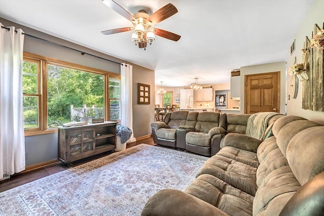 6705 Brian Dr, Waterford, WI 53185 - living room featuring ceiling fan, baseboards, a chandelier, and wood finished floors