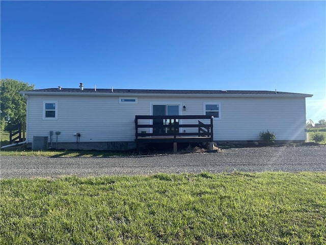 163 230th St, Osceola, WI 54020 - back of property with a deck, a lawn, and central air condition unit
