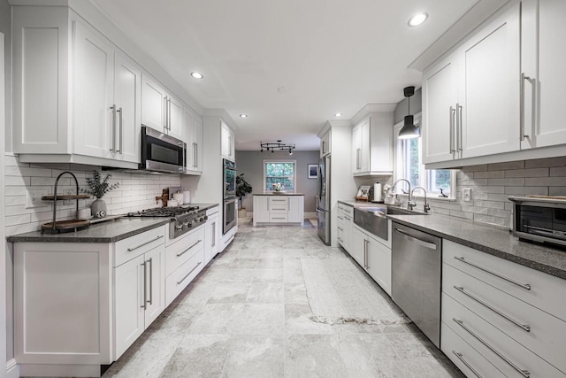 18005 Lisa Ln, Brookfield, WI 53045 - kitchen with appliances with stainless steel finishes, a sink, recessed lighting, white cabinetry, and baseboards