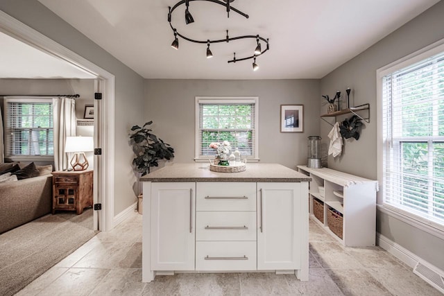 18005 Lisa Ln, Brookfield, WI 53045 - interior space featuring white cabinets, plenty of natural light, stone countertops, and baseboards