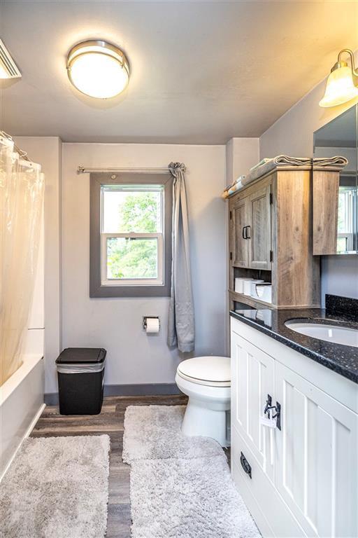 W9952 State Highway 54, Black River Falls, WI 54615 - full bathroom featuring toilet, vanity, healthy amount of natural light, and baseboards