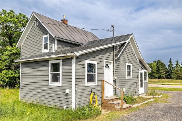 W9952 State Highway 54, Black River Falls, WI 54615 - view of property exterior with a chimney and entry steps