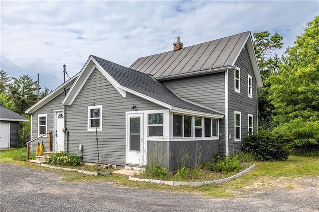 W9952 State Highway 54, Black River Falls, WI 54615 - view of side of home with a standing seam roof, a chimney, and metal roof