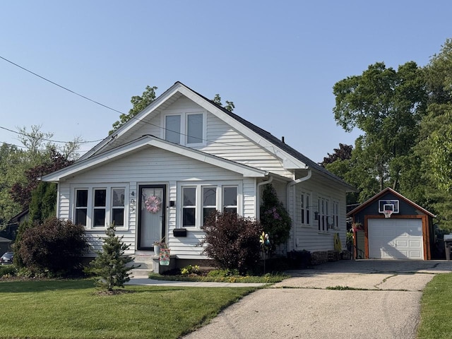 405 W Washington St, Waterford, WI 53185 - bungalow-style house with a garage, an outbuilding, driveway, and a front yard