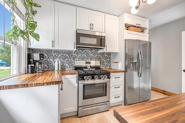 405 W Washington St, Waterford, WI 53185 - kitchen with butcher block counters, appliances with stainless steel finishes, and backsplash