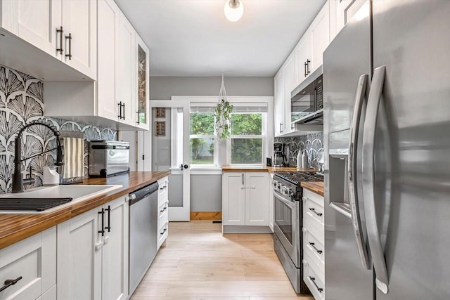 405 W Washington St, Waterford, WI 53185 - kitchen with stainless steel appliances, wood counters, and tasteful backsplash
