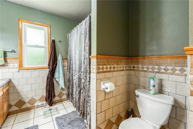 5603 170th St, Chippewa Falls, WI 54729 - full bathroom featuring tile walls, toilet, vanity, a wainscoted wall, and tile patterned flooring