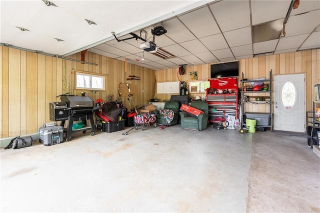 5603 170th St, Chippewa Falls, WI 54729 - garage featuring wooden walls and a garage door opener